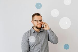 pexels-photo-6214838-6214838 Professional man talking on smartphone with overlay arrow graphics, symbolizing communication.
